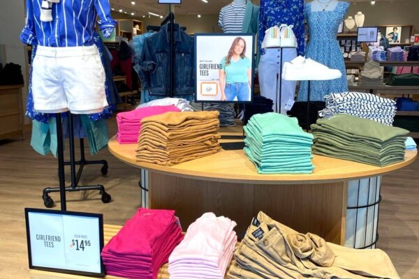 interior view of J.Crew. View of womens clothing with sales sign near clothing.